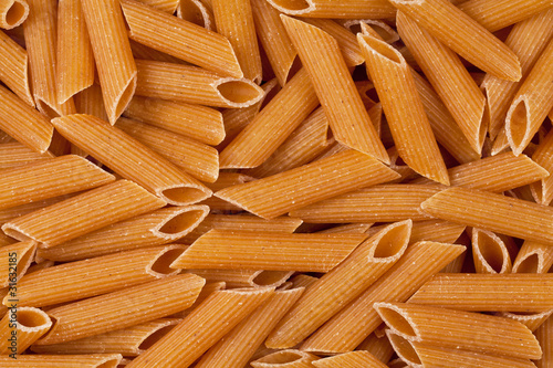Closeup of uncooked wholewheat italian pasta - penne