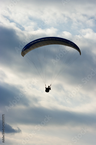 Paraglider silhouette and dramatic sky