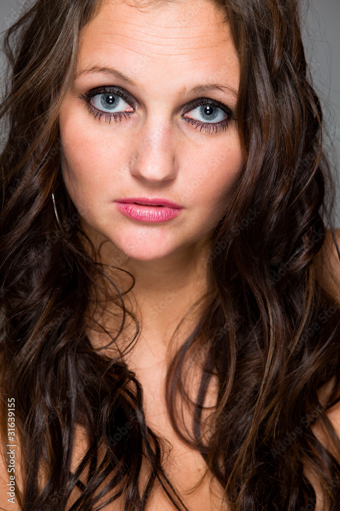Sensual girl with long brown hair and expressive blue eyes. Sensual girl with long brown hair and expressive blue eyes.