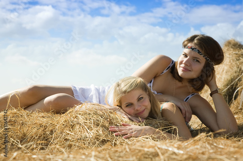 country girls resting on hay