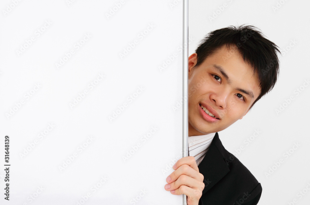 An Asian businessman holding a blank whiteboard An Asian businessman holding a blank whiteboard