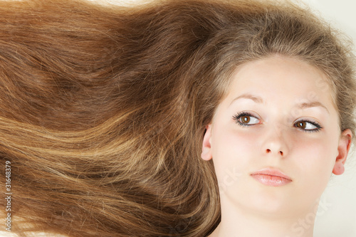 Healthy beautiful long hair closeup in motion created by wind