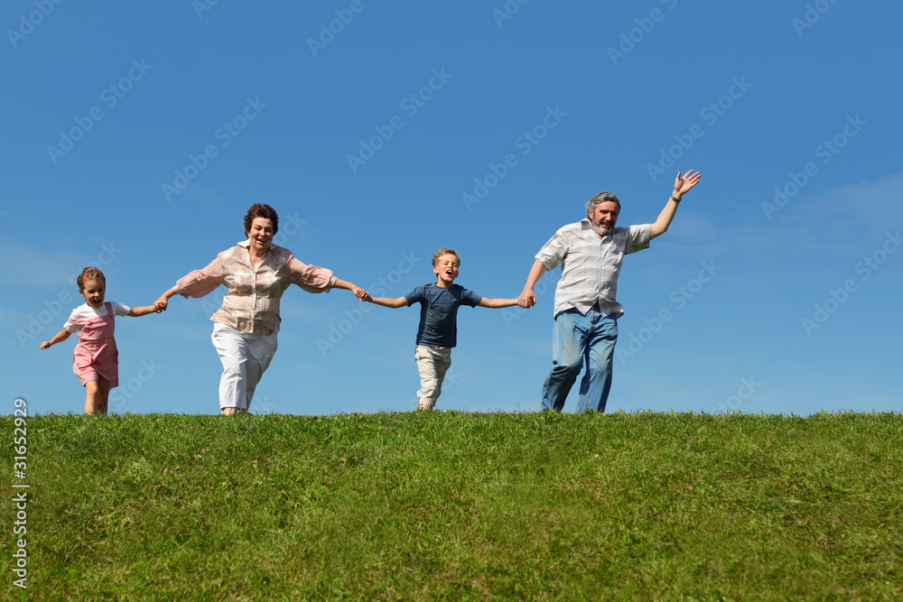 grandchildren and their grandparents running on hill grandchildren and their grandparents running on hill