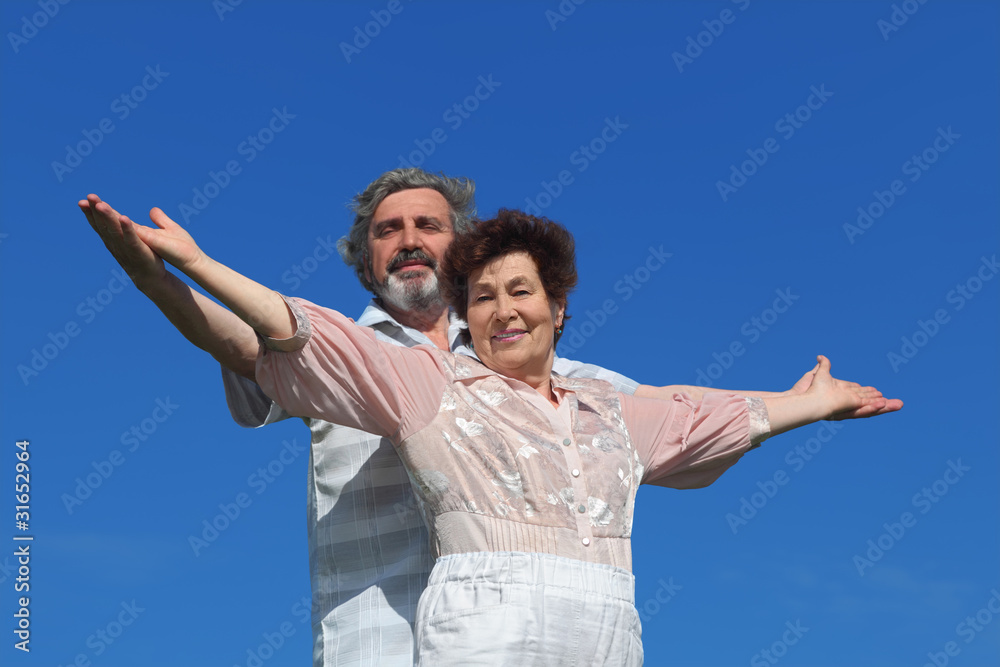 man and woman standing, smiling and looking at camera man and woman standing, smiling and looking at camera