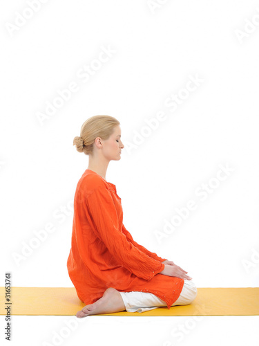 series or yoga photos. young woman in virasana pose on yellow pi photo