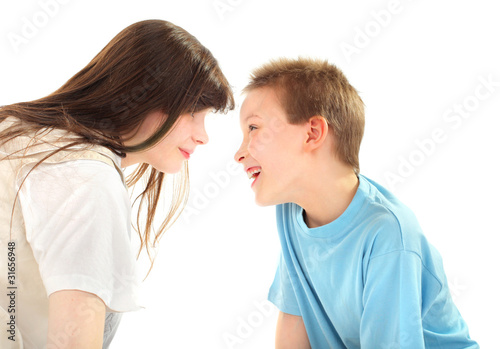 happy brother and sister laughing isolated on the white © Sabphoto