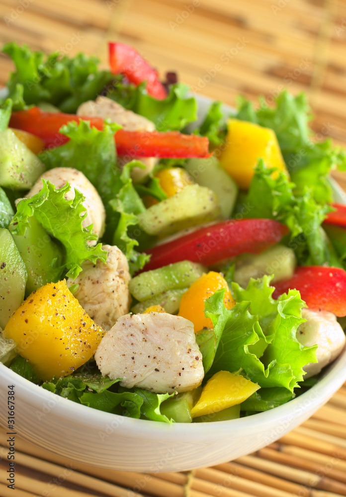 Chicken salad with lettuce, mango, bell pepper and cucumber Chicken salad with lettuce, mango, bell pepper and cucumber
