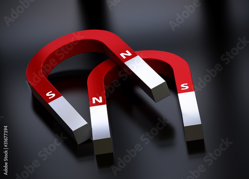 2 red horseshoe magnets over a black background photo