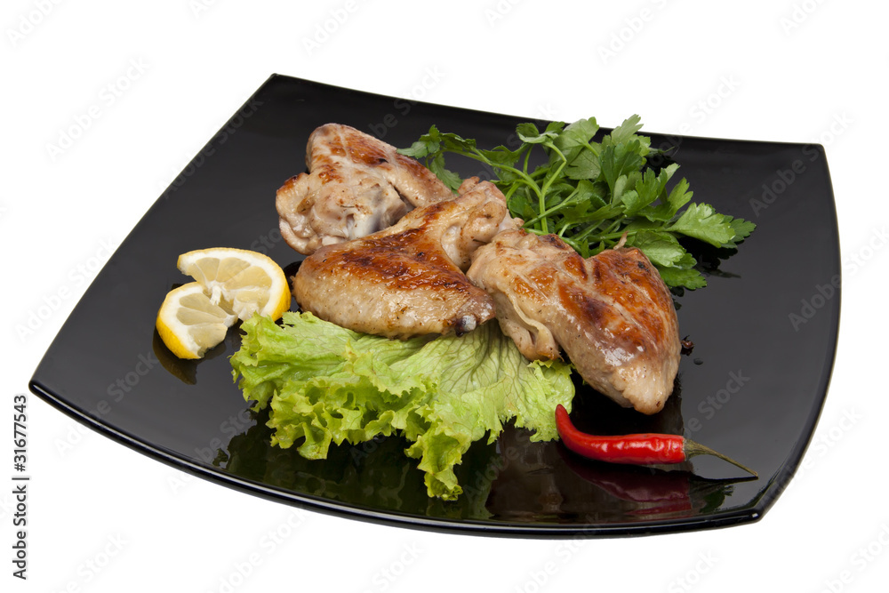 Chicken wings grilled with herbs, pepper and lemon