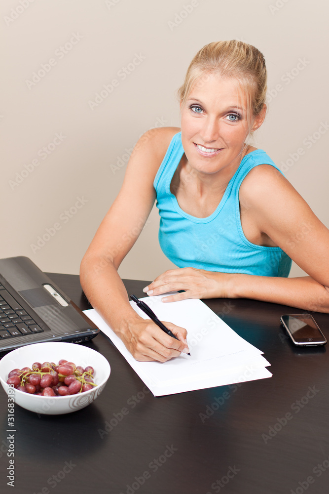 young pretty student works on her essay young pretty student works on her essay