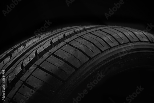 Car tire on black background © Kavita