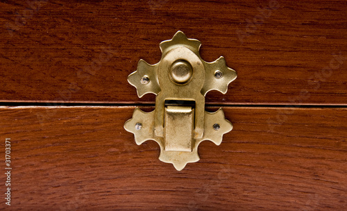 The lock of a wooden casket close up photo