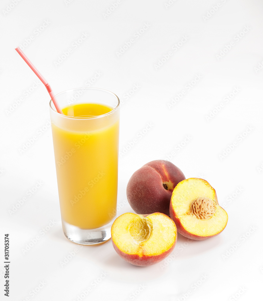 Glass with fresh peach juice near the slice peaches Glass with fresh peach juice near the slice peaches