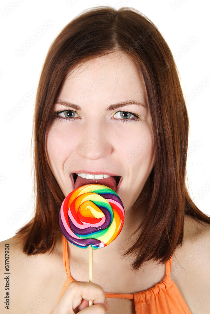 young brunette girl  licking big multicolored lollipop, isolated