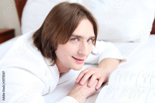 portrait of a young man in bed