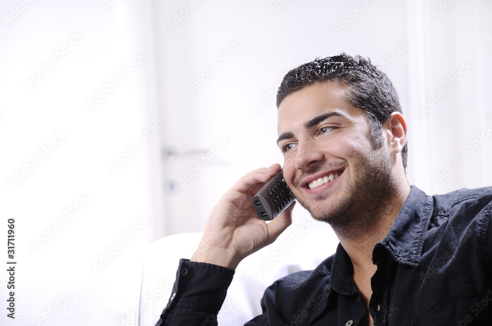 young man using telephone - obrazy, fototapety, plakaty 