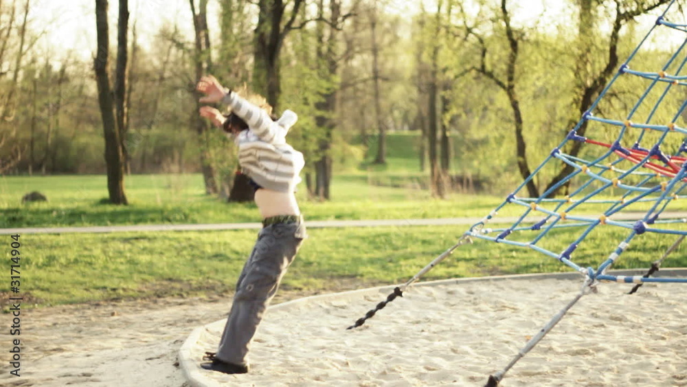 Young boy having fun in playground, slow motion, 60fps Young boy having fun in playground, slow motion, 60fps