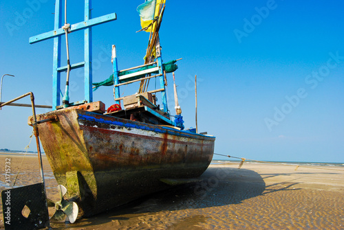 fisherman boat on the sea shore © zmkstudio