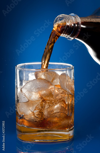 Filling glass with cola