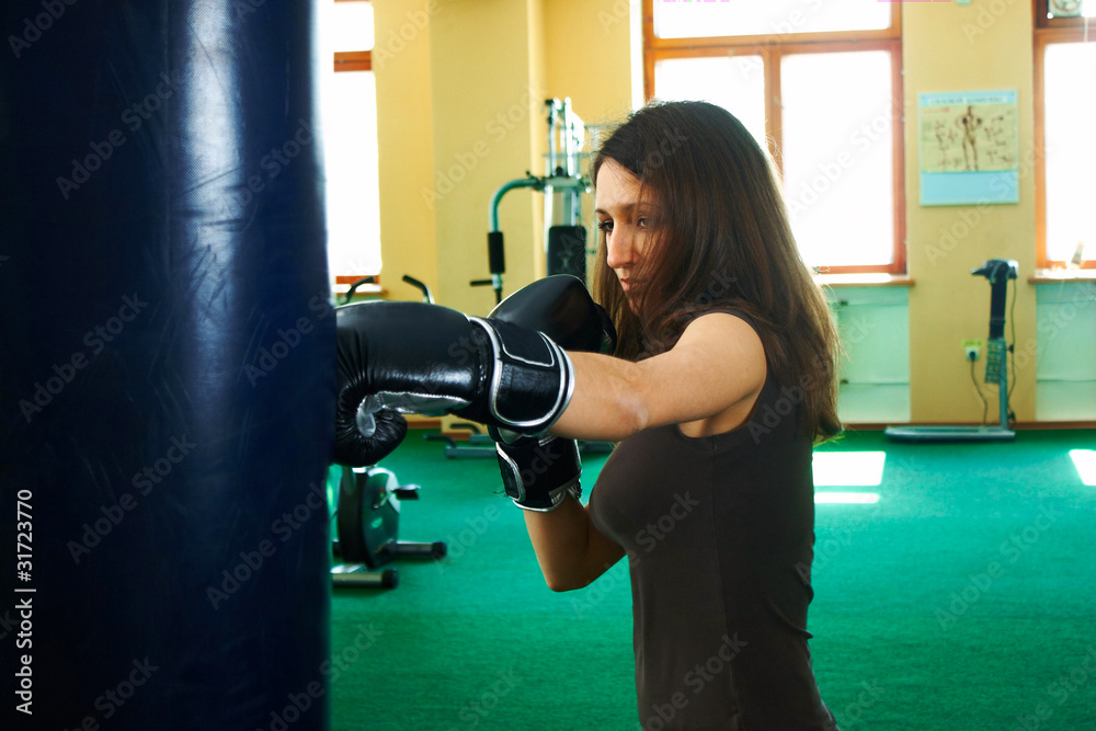 Brunette girl in boxing at the gym
