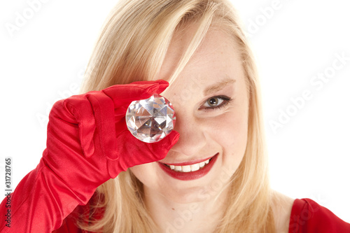 holding gem to eye
