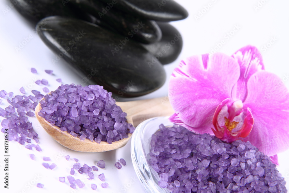 Lavender spa salt, spa stones and an orchid flower Lavender spa salt, spa stones and an orchid flower