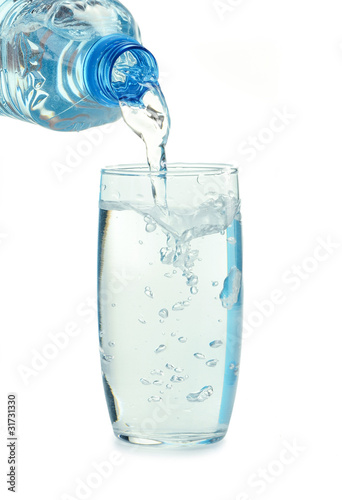 Bottle and glass of water isolated on white