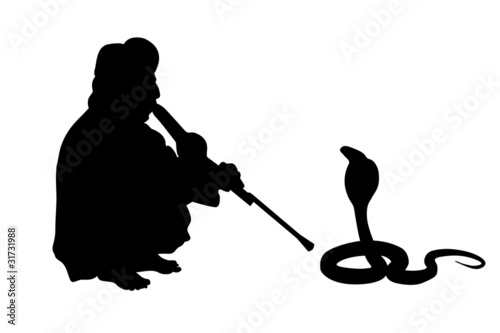 indian fakir sitting with cobra silhouettes photo