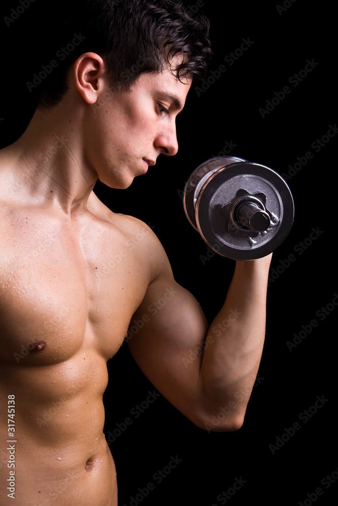 Powerful muscular young man lifting weights Powerful muscular young man lifting weights