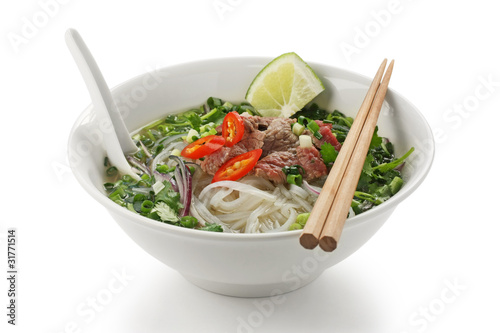 Pho bo , Vietnamese rice noodle soup with sliced rare beef