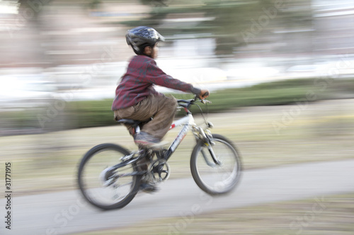 Young boy riding a bike © derejeb
