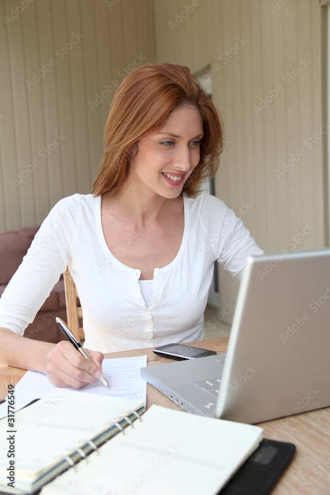 Woman working at home on laptop computer Woman working at home on laptop computer