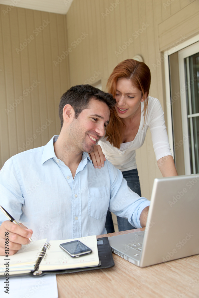Self-employed man working at home with wife Self-employed man working at home with wife