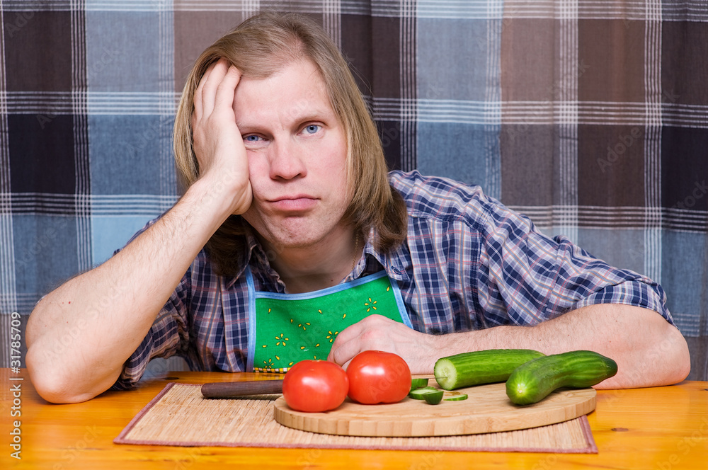 Sad tired man with tomatoes and cucumbers Sad tired man with tomatoes and cucumbers
