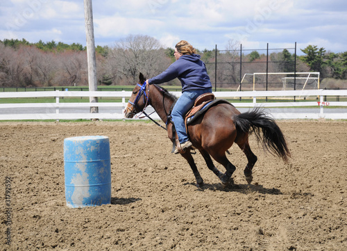 Young woman barrel racing