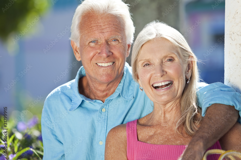 Happy Senior Couple Smiling Outside in Sunshine Happy Senior Couple Smiling Outside in Sunshine