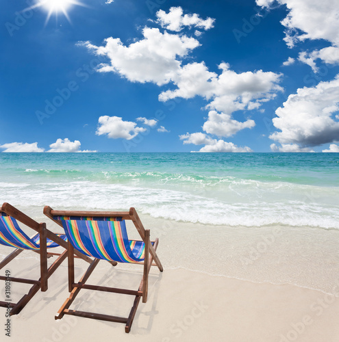beach chair on white sand © SuriyaPhoto