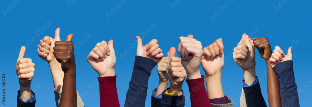 Fototapeta premium Multiracial Thumbs Up Against Blue Sky