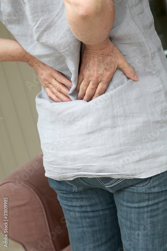 Closeup on senior woman with backache photo