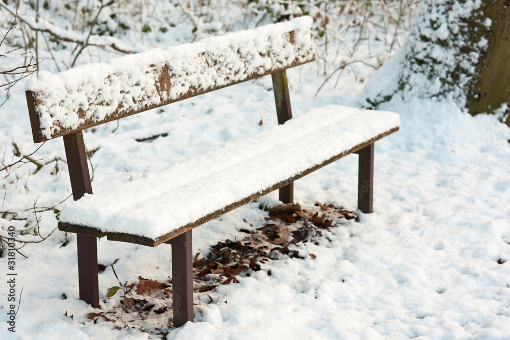 park bench under pack of snow