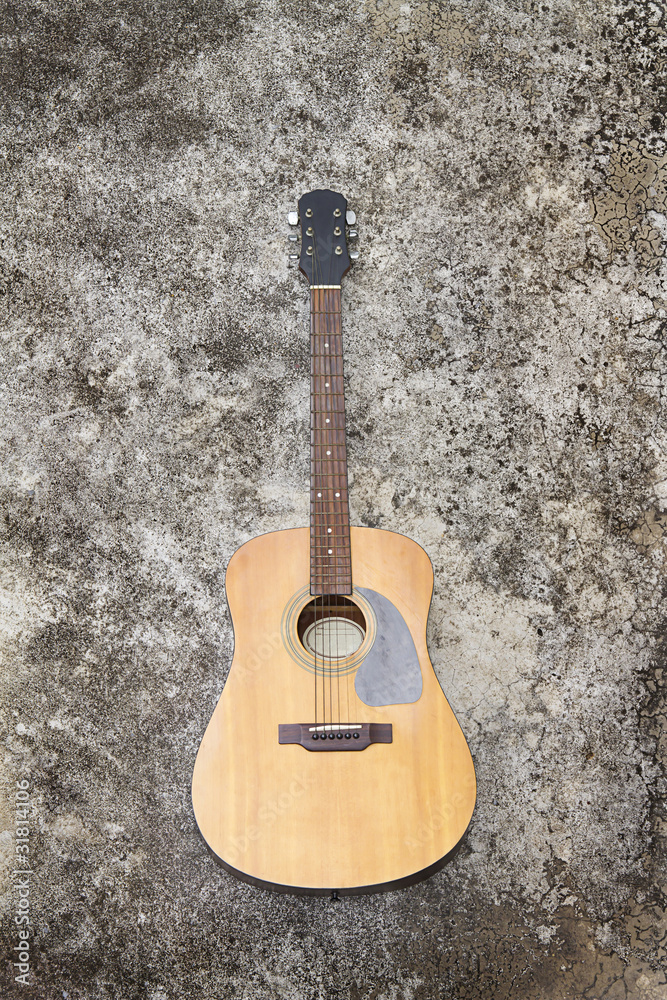 Spanish guitar on old cement floor
