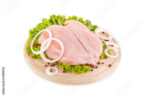 Fresh raw chicken breasts on chopping board