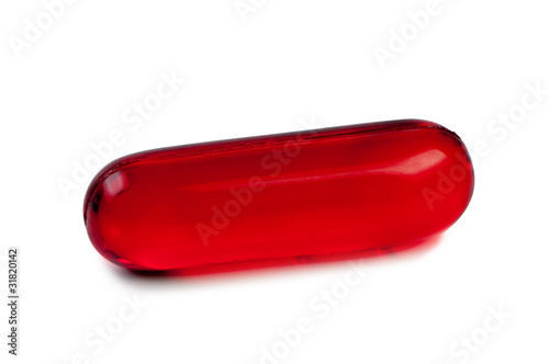 Red pill close up isolated.
