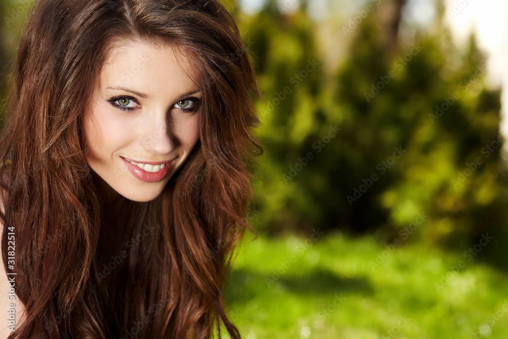 Smiling beautiful woman laying on grass Smiling beautiful woman laying on grass
