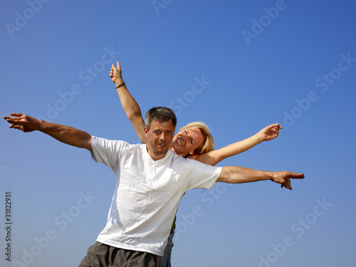 Happy couple in front of blue sky