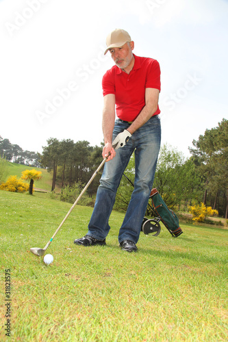 Senior man standing on golf course