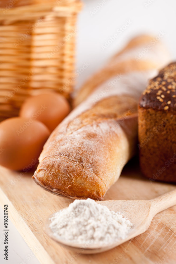 Naklejka premium bread, flour, eggs and kitchen utensil