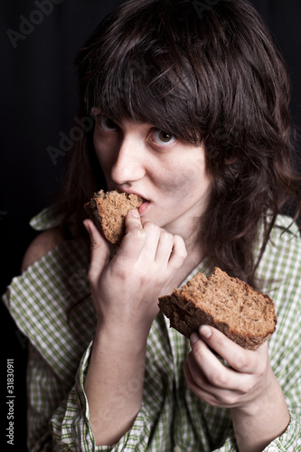 beggar woman eating bread