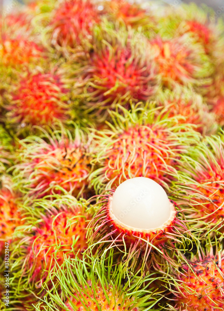 Tropical Fruit,white pulp rambutan among red rambutan. Tropical Fruit,white pulp rambutan among red rambutan.
