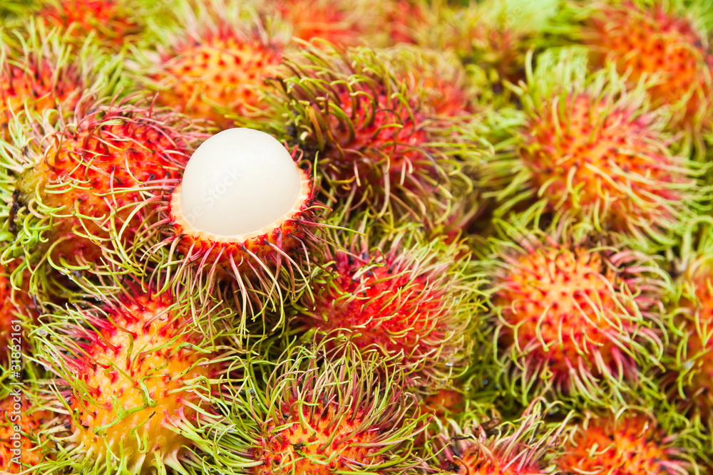 Tropical Fruit,white pulp rambutan among red rambutan. Tropical Fruit,white pulp rambutan among red rambutan.